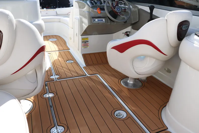 Slide: The Image of 2007 Crownline 240 EX boat interior with wood flooring and white seating. - 28