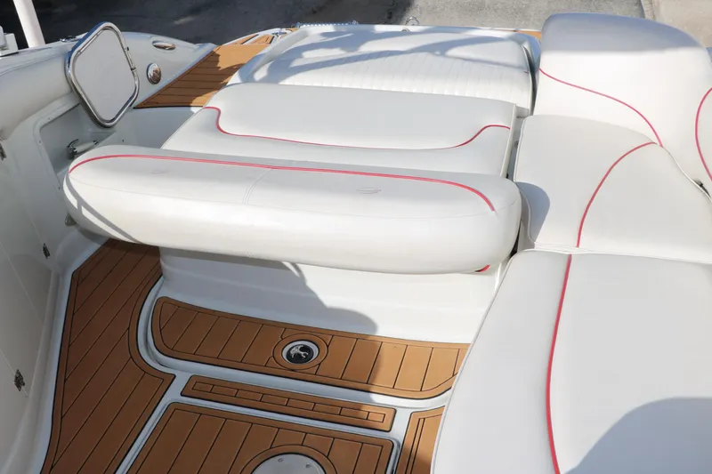 Slide: The Image of 2007 Crownline 240 EX boat interior with white seating and teak flooring. - 29