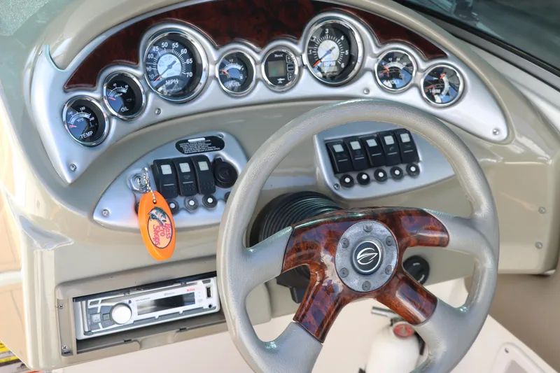 Slide: The Image of Dashboard of 2007 Crownline 240 EX boat with gauges and steering wheel. - 32