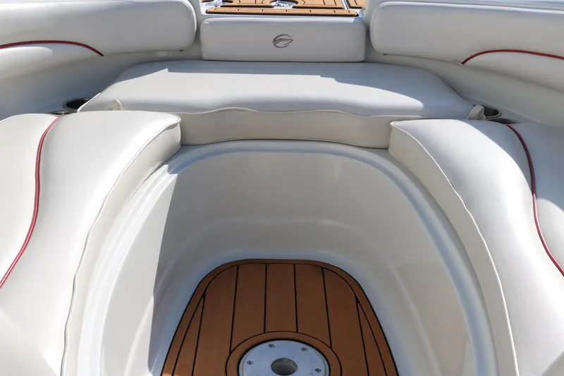 Slide: The Image of 2007 Crownline 240 EX boat interior with white seating and wood flooring. - 34