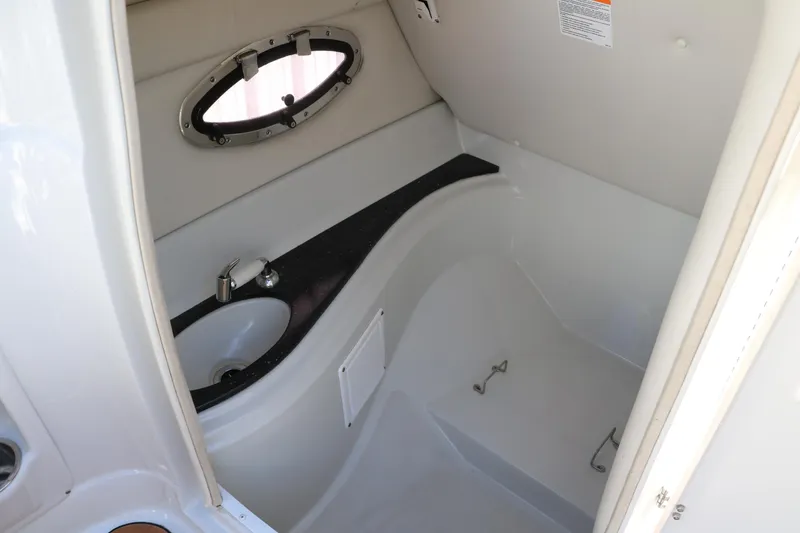 Slide: The Image of 2007 Crownline 240 EX boat interior with sink and porthole window. - 38