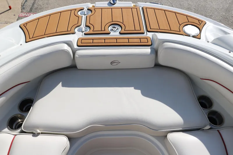 Slide: The Image of 2007 Crownline 240 EX boat interior with cushioned seating and wooden accents. - 40