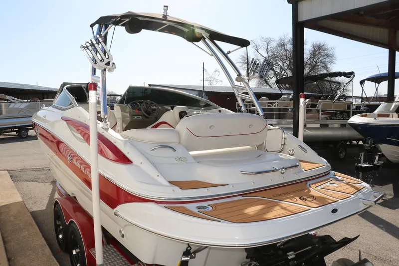 Slide: The Image of 2007 Crownline 240 EX boat with red accents, docked at a marina. - 6