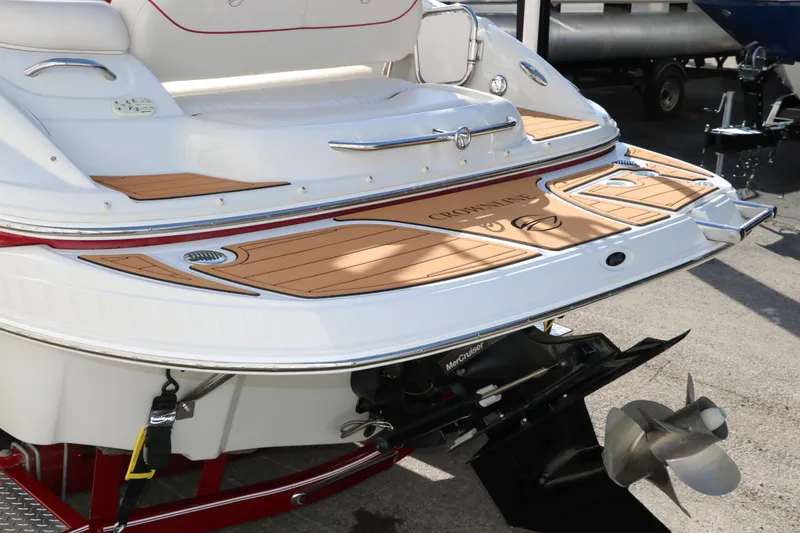 Slide: The Image of 2007 Crownline 240 EX boat stern with teak swim platform and outboard motor. - 7