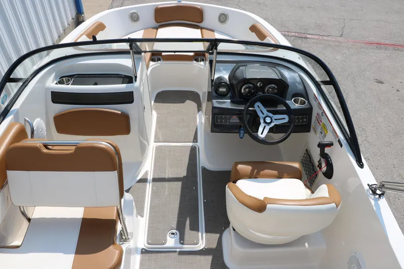 Slide: The Image of 2020 Bayliner VR5 Bowrider I/O interior with tan and white seating, steering wheel, and dashboard. - 20
