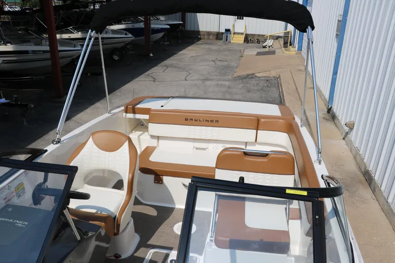 Slide: The Image of 2020 Bayliner VR5 Bowrider I/O with tan and white interior, docked outdoors. - 24