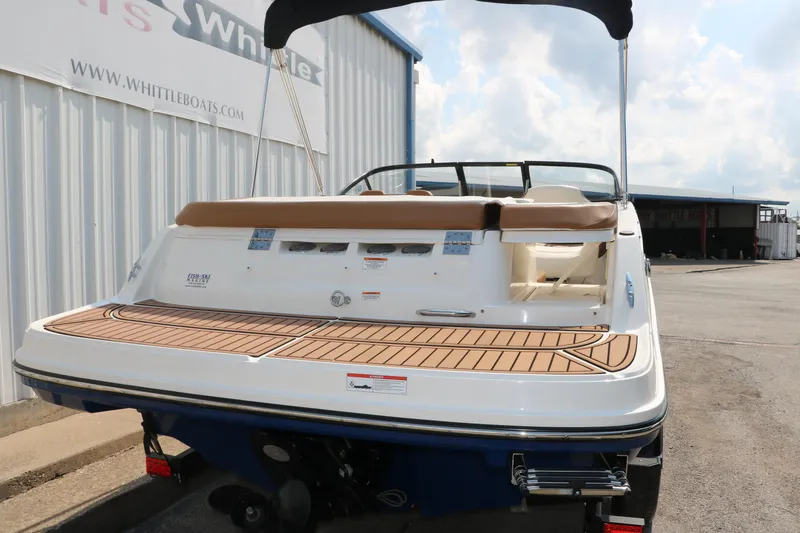 Slide: The Image of 2020 Bayliner VR5 Bowrider I/O boat with teak swim platform, docked outdoors. - 5