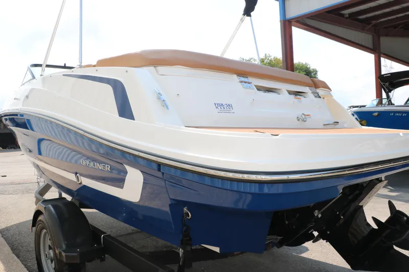 Slide: The Image of 2020 Bayliner VR5 Bowrider I/O boat on trailer, rear view, in a marina setting. - 7