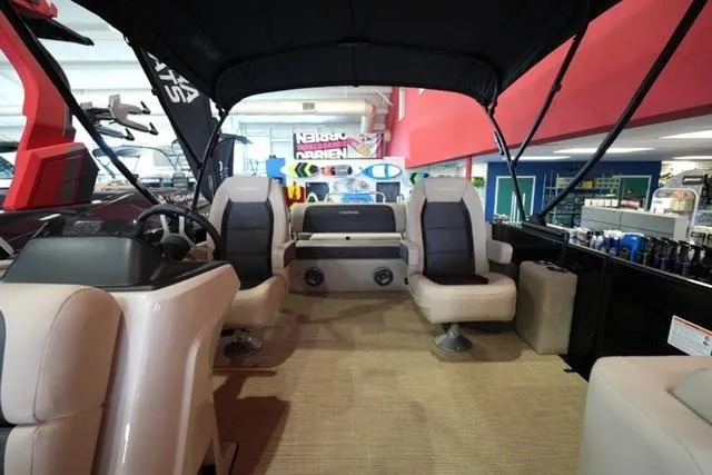 Slide: The Image of 2025 Harris Cruiser 210 interior with plush seating and modern design in showroom. - 6