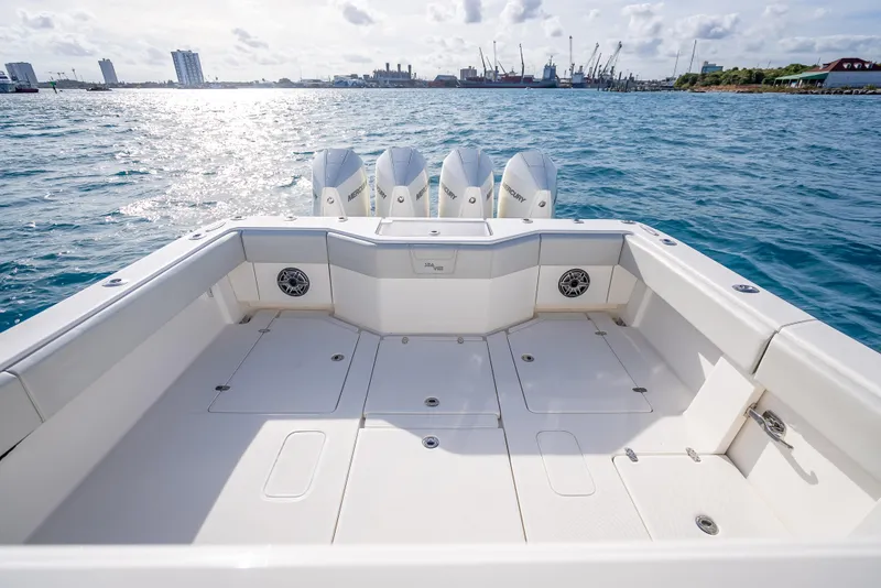 Slide: The Image of 2024 SeaVee 390B boat deck with quad engines on open water. - 10