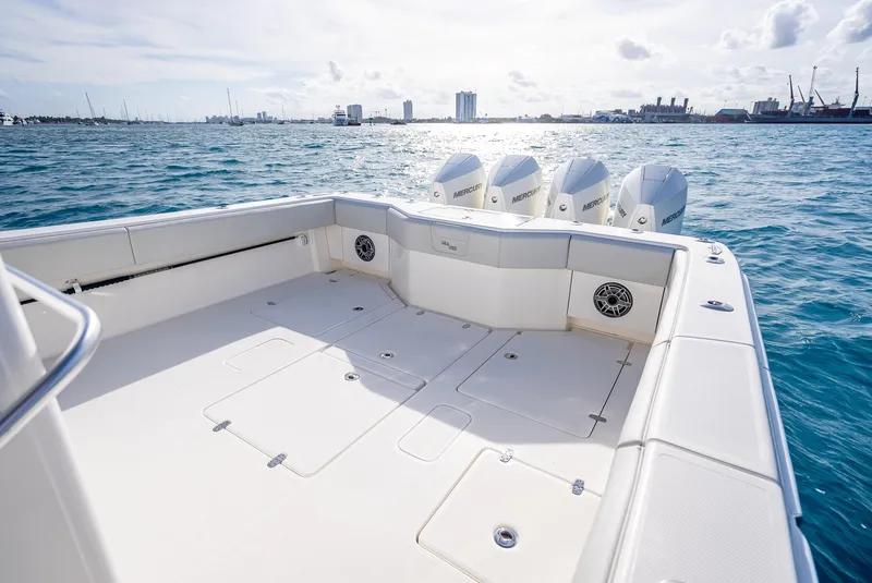 Slide: The Image of 2024 SeaVee 390B boat deck with quad outboard engines on open water. - 12