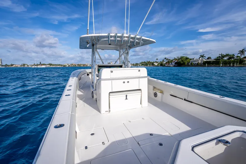 Slide: The Image of 2024 SeaVee 390B boat on blue ocean, clear sky, spacious deck, modern design. - 13