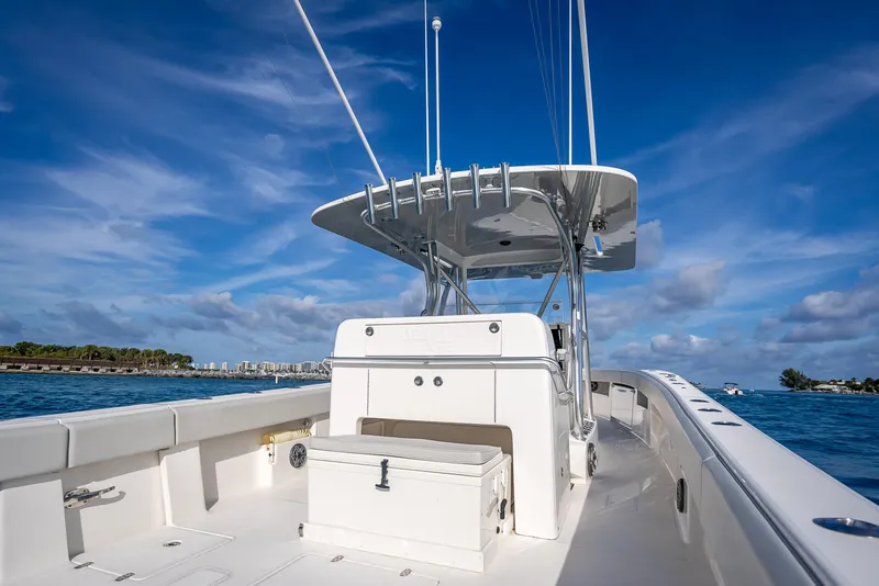 Slide: The Image of 2024 SeaVee 390B boat on water, clear sky, spacious deck, modern design. - 15