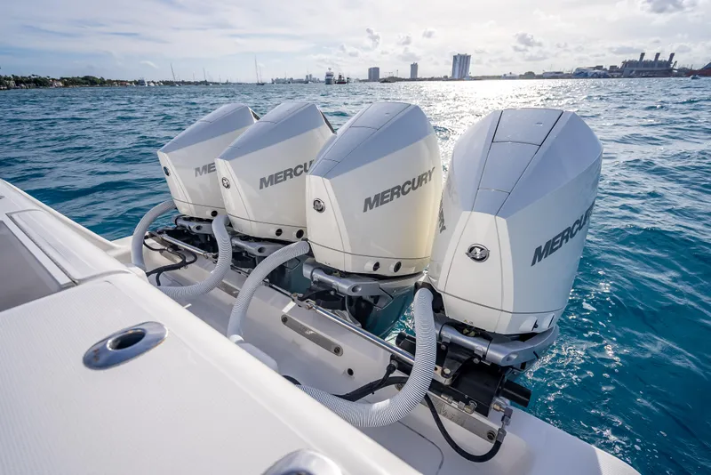 Slide: The Image of 2024 SeaVee 390B boat with triple Mercury outboard engines on open water. - 16