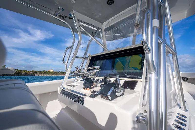 Slide: The Image of 2024 SeaVee 390B boat console with advanced navigation system and controls, under clear blue sky. - 18