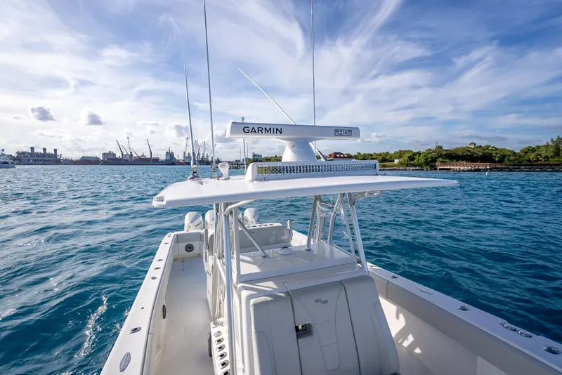 Slide: The Image of 2024 SeaVee 390B boat on water, featuring Garmin equipment, under a clear blue sky. - 23