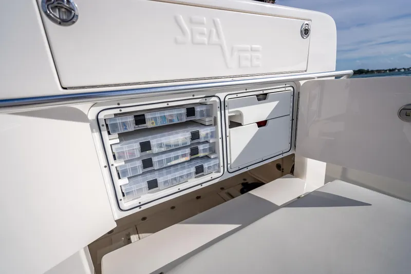 Slide: The Image of 2024 SeaVee 390B boat storage compartments with organized tackle boxes and sleek design. - 27