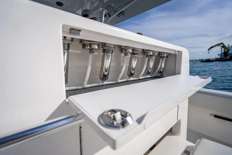 Slide: The Image of 2024 SeaVee 390B boat detail with rod holders, ocean view in background. - 28