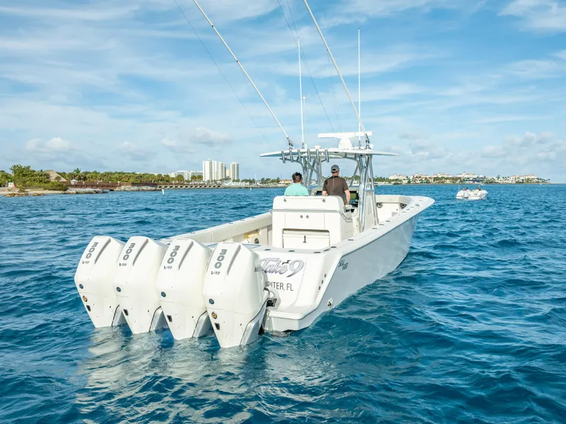 Slide: The Image of 2024 SeaVee 390B boat with four engines cruising on clear blue water. - 3