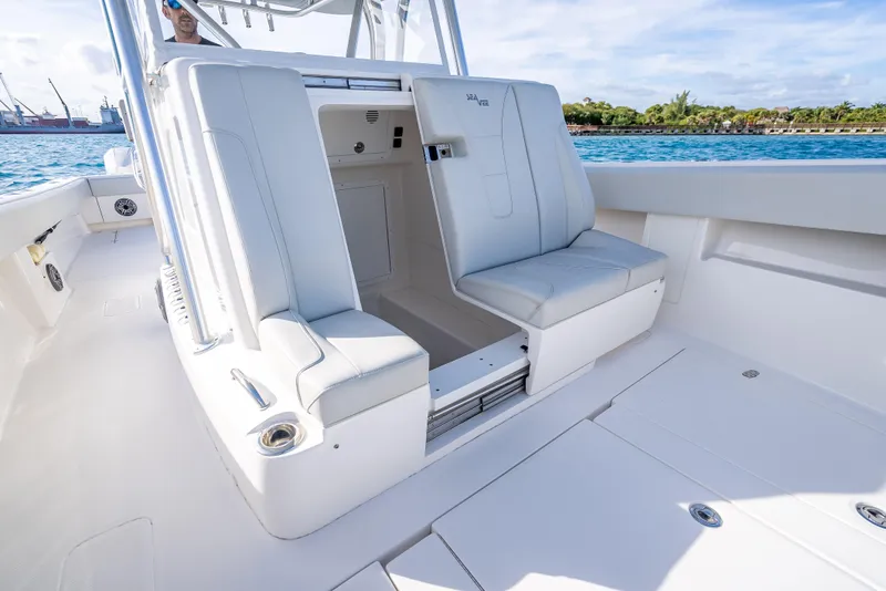 Slide: The Image of 2024 SeaVee 390B boat interior with white seating and open storage compartment. - 32