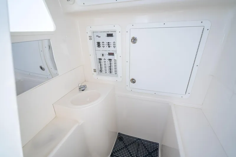 Slide: The Image of 2024 SeaVee 390B interior with control panel, sink, and storage compartment. - 33