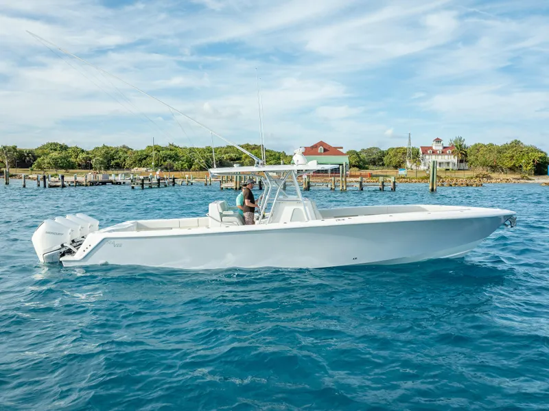 Slide: The Image of 2024 SeaVee 390B boat cruising on clear blue water near a dock. - 37