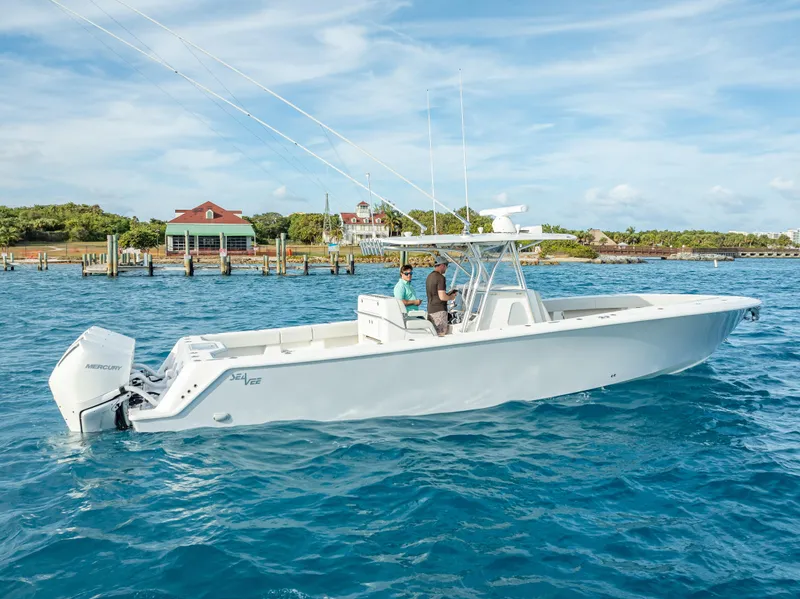 Slide: The Image of 2024 SeaVee 390B boat on clear blue water near a coastal dock. - 39