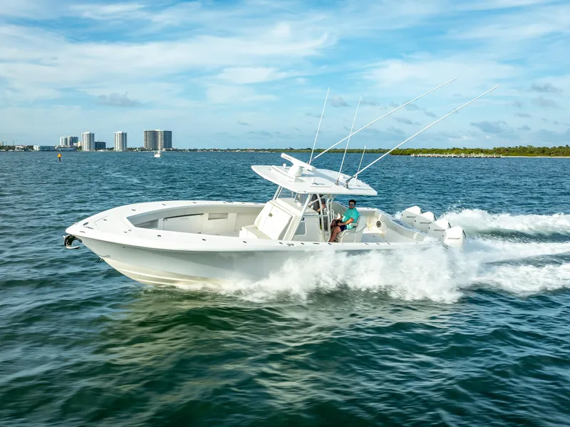 Slide: The Image of 2024 SeaVee 390B boat cruising on open water under a clear sky. - 4