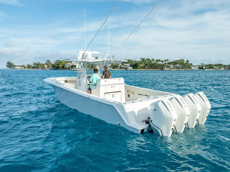 Slide: The Image of 2024 SeaVee 390B boat with multiple outboard engines cruising on clear blue water. - 40