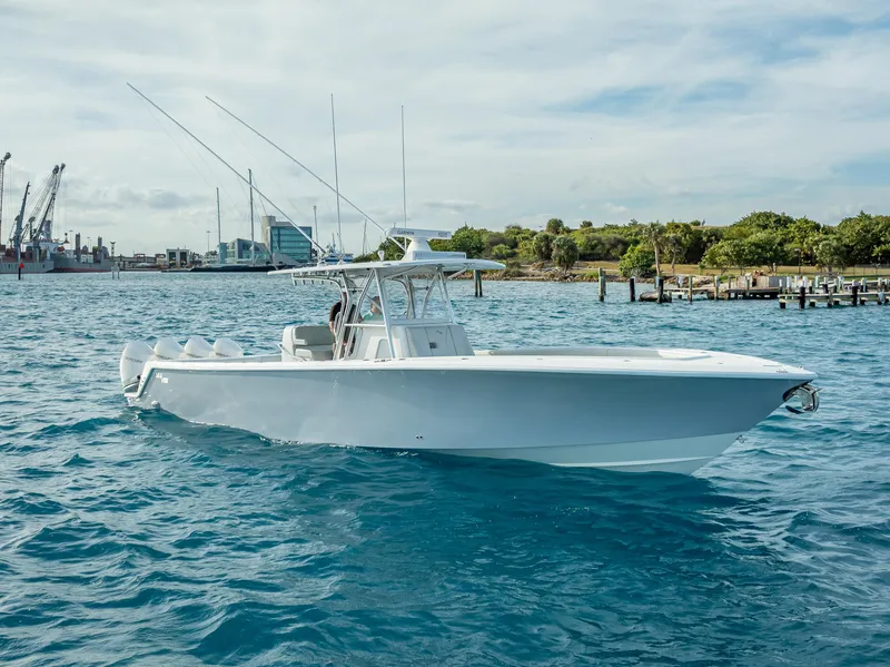 Slide: The Image of 2024 SeaVee 390B boat on water, clear sky, and distant shoreline. - 5