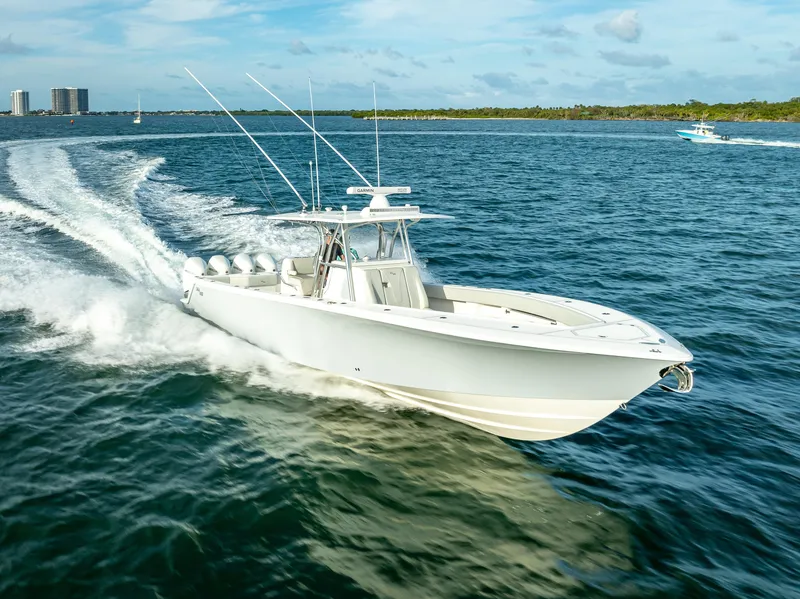 Slide: The Image of 2024 SeaVee 390B boat cruising on open water under a clear sky. - 7