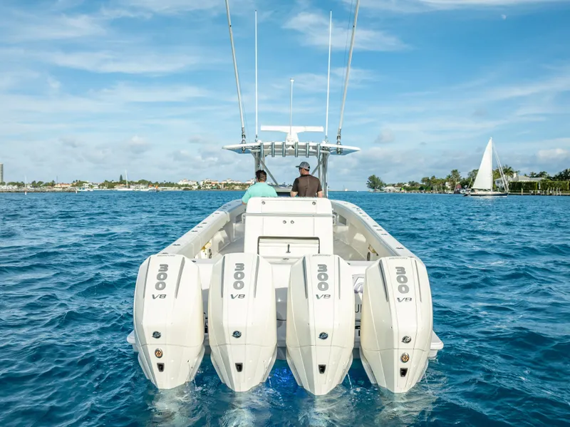 Slide: The Image of 2024 SeaVee 390B boat with quad engines cruising on blue water under clear skies. - 9