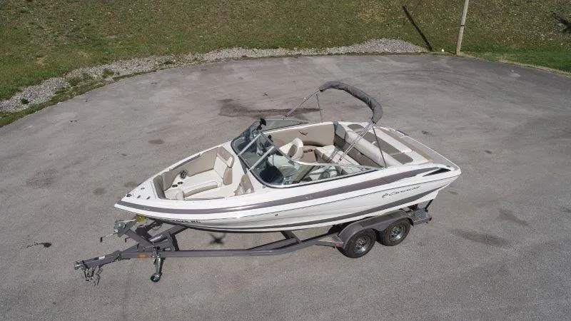 Slide: The Image of 2019 Crownline 215 SS boat on trailer, parked on concrete surface. - 1