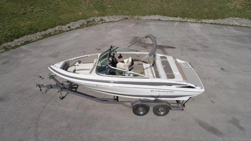 Slide: The Image of 2019 Crownline 215 SS boat on trailer, aerial view, parked on concrete surface. - 2