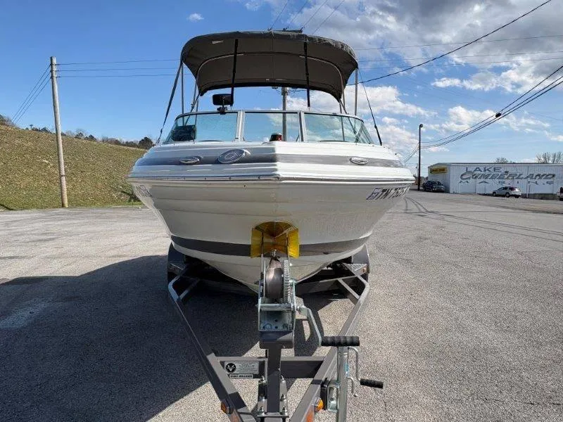 Slide: The Image of 2019 Crownline 215 SS boat on trailer under clear sky. - 22