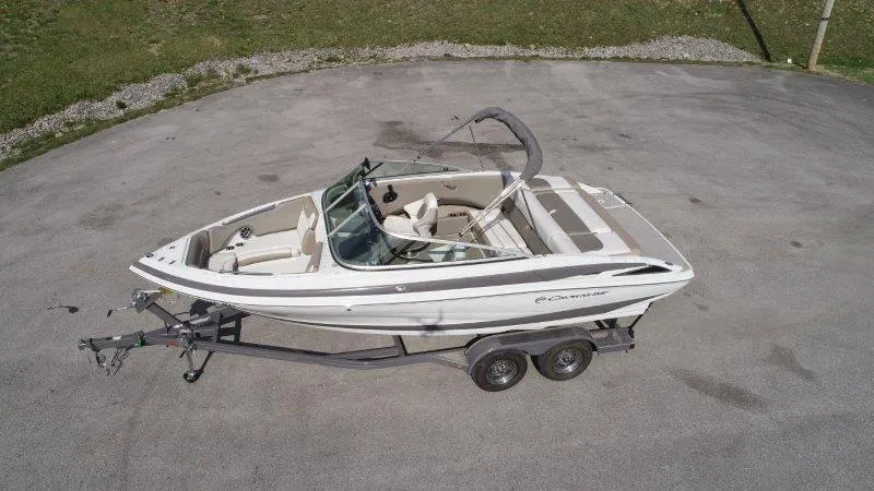 Slide: The Image of 2019 Crownline 215 SS boat on trailer, aerial view, parked on concrete surface. - 3