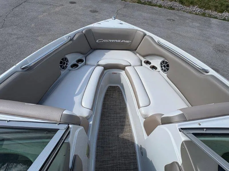 Slide: The Image of 2019 Crownline 215 SS boat interior with cushioned seating and speakers. - 30