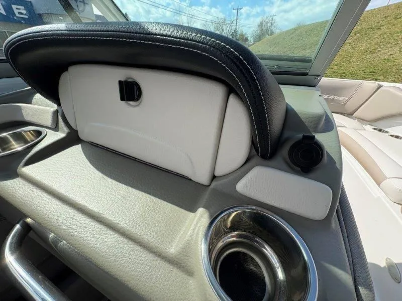 Slide: The Image of 2019 Crownline 215 SS boat interior with cup holder and storage compartment. - 32