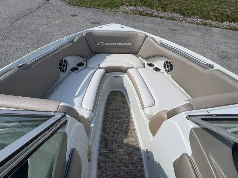 Slide: The Image of 2019 Crownline 215 SS boat interior with cushioned seating and cup holders. - 40