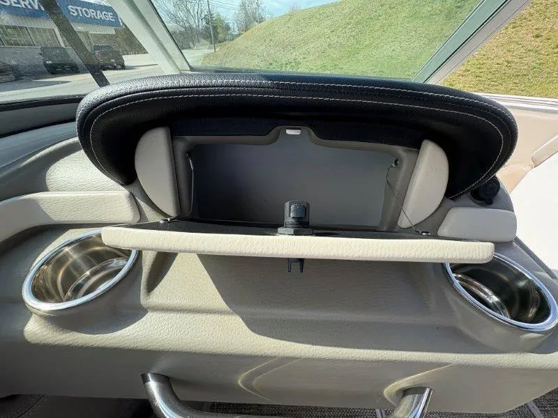 Slide: The Image of 2019 Crownline 215 SS boat dashboard with storage compartment and cup holders. - 41