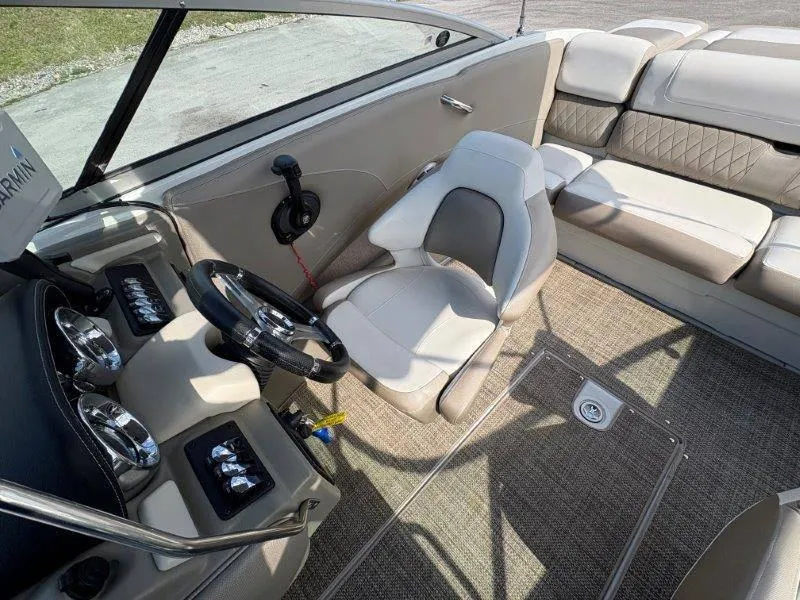 Slide: The Image of 2019 Crownline 215 SS boat interior with steering wheel, seating, and dashboard controls. - 42