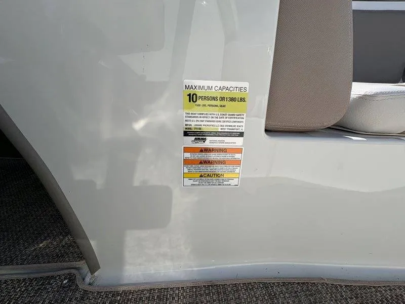 Slide: The Image of 2019 Crownline 215 SS capacity label, maximum 10 persons or 1380 lbs, safety warnings visible. - 43