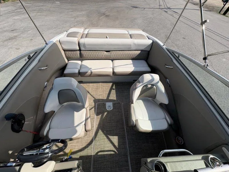 Slide: The Image of 2019 Crownline 215 SS boat interior with beige seating and steering wheel. - 44