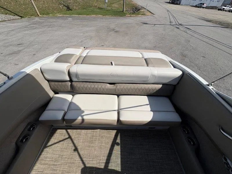 Slide: The Image of 2019 Crownline 215 SS boat interior with beige seating and carpeted floor. - 46