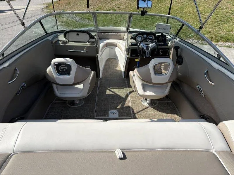 Slide: The Image of 2019 Crownline 215 SS boat interior with beige seating and modern dashboard. - 47