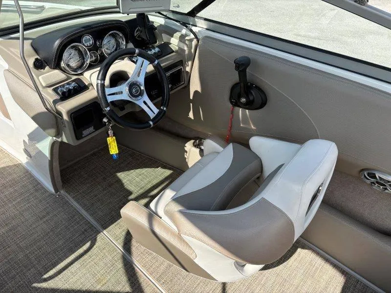 Slide: The Image of 2019 Crownline 215 SS boat interior with steering wheel and dashboard controls. - 49