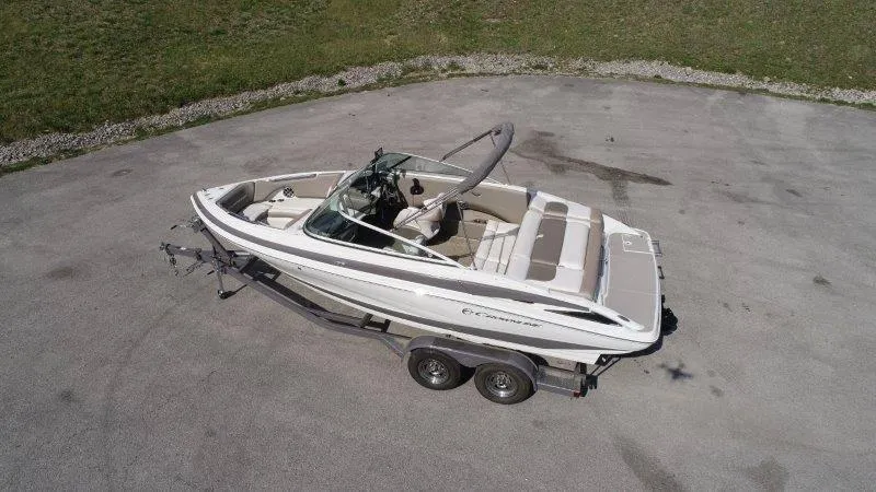 Slide: The Image of 2019 Crownline 215 SS boat on trailer, parked on concrete surface. - 5