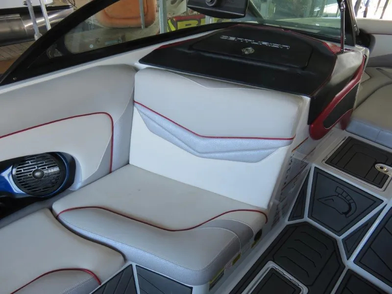 Slide: The Image of 2017 Centurion Ri237 boat interior with white and red seating, speaker, and flooring. - 10