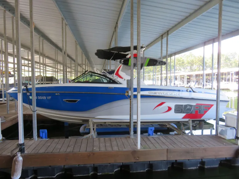 Slide: The Image of 2017 Centurion Ri237 boat docked under covered marina. - 2