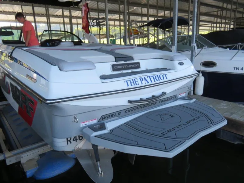 Slide: The Image of 2017 Centurion Ri237 boat named "The Patriot" docked in a marina. - 3